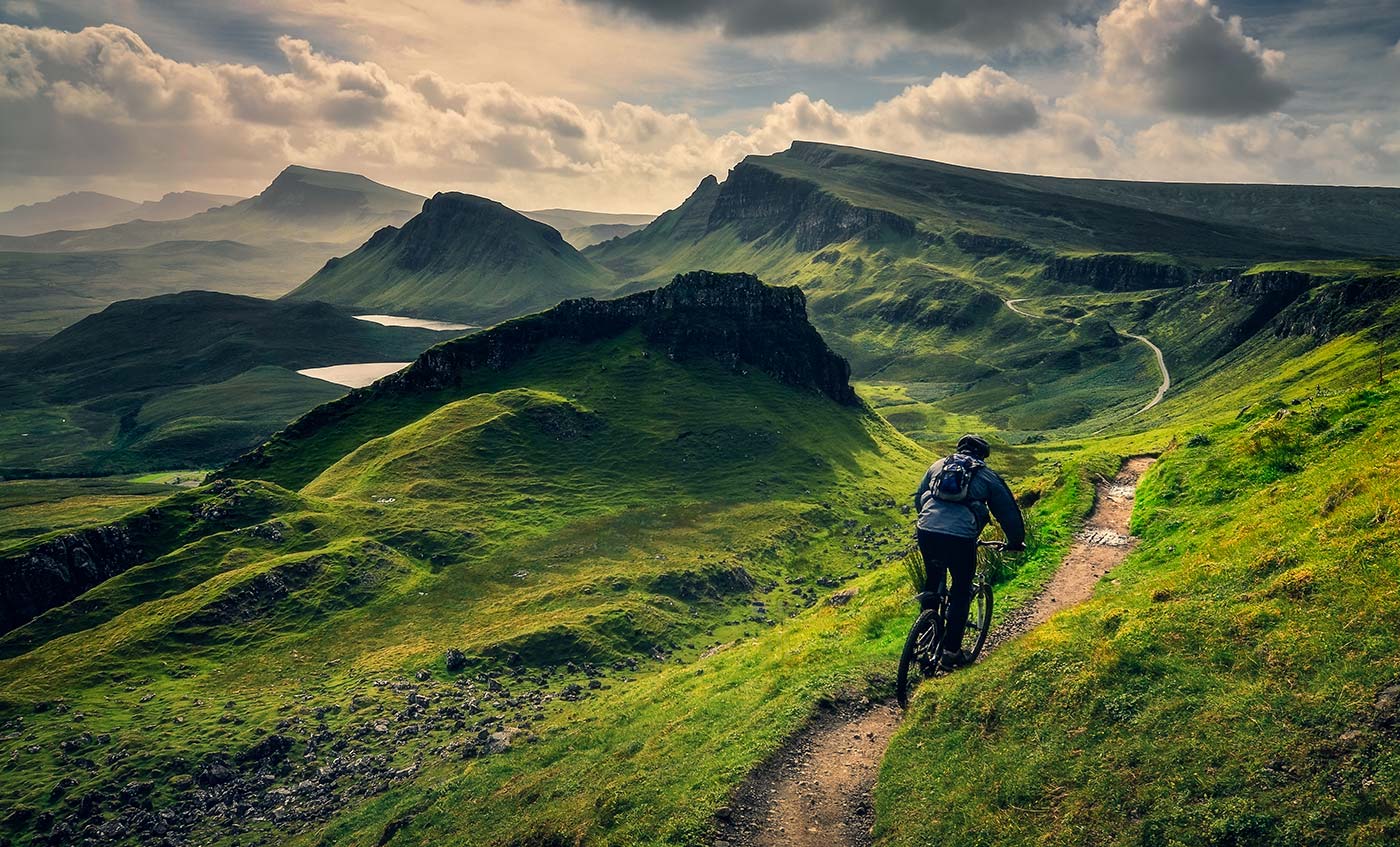 Mountain biker riding through rough Scottish landscape