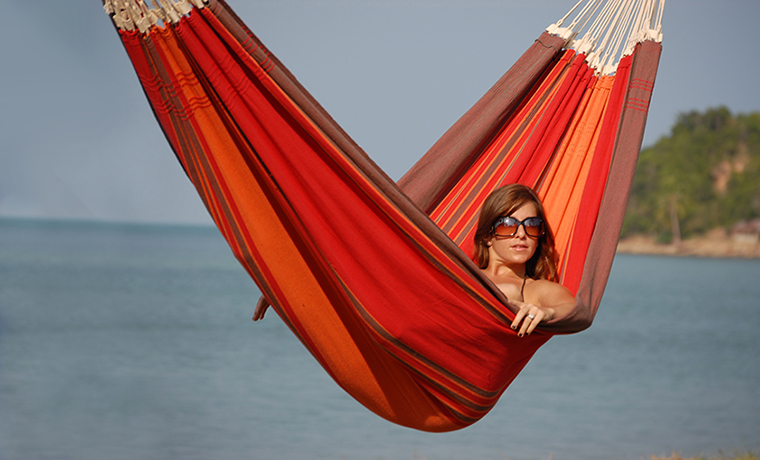 A lady lying in a double hammock
