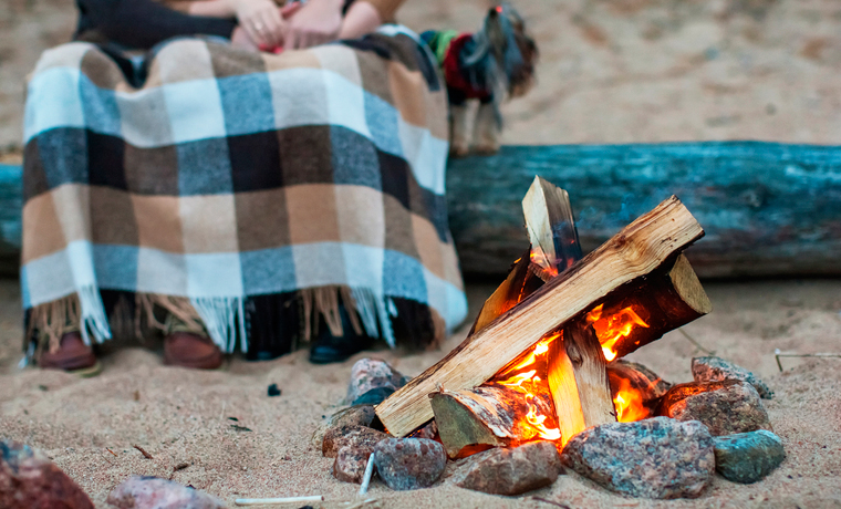 Couple on beach with camp fire