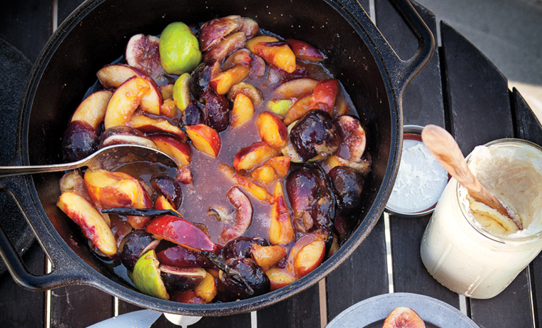 Glazed peaches and figs in pan