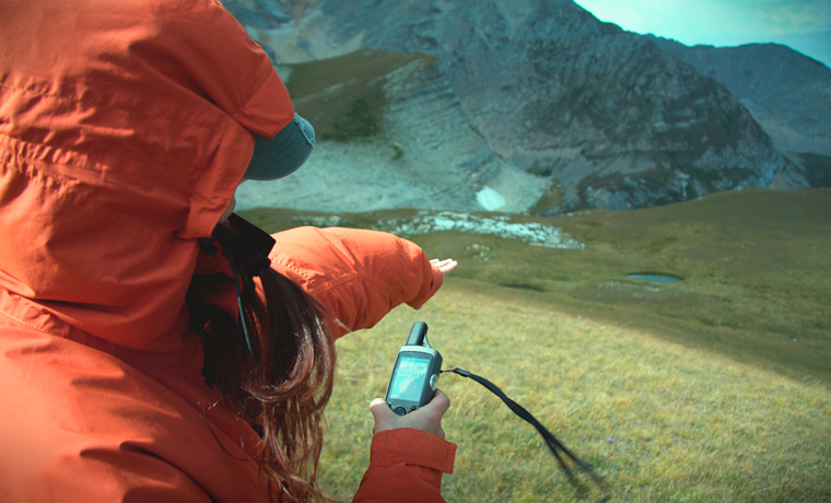 Woman in mountains with gps