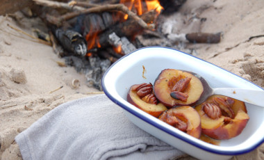 Pecan peaches by a campfire