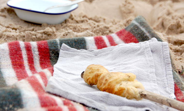 Cooked bannock bread on a beach blanket