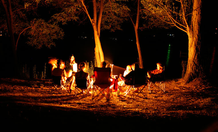 People sat around a campfire