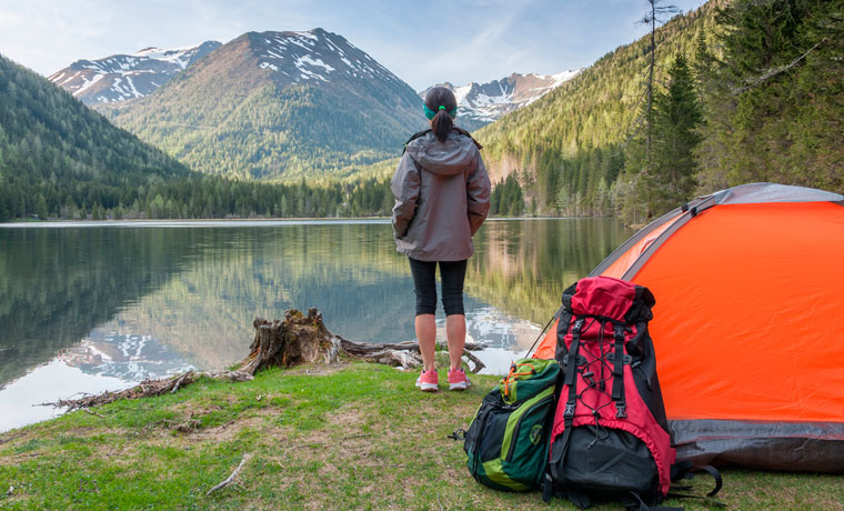 Lady camping by a lake