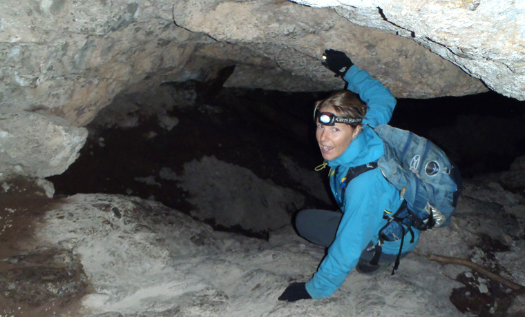 Woman climbing in a cave