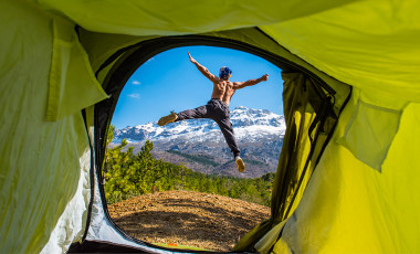 Man jumping out of tent