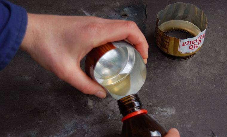 Decanting liquid alcohol from a soda can stove back into the bottle