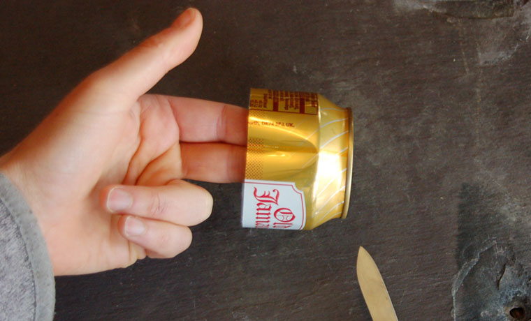 Showing the fold in the side of a soda can