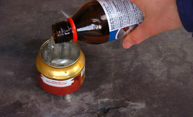 Pouring liquid alcohol into a soda can stove
