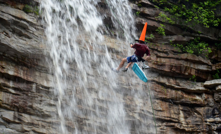 Extreme ironing waterfall abseiler