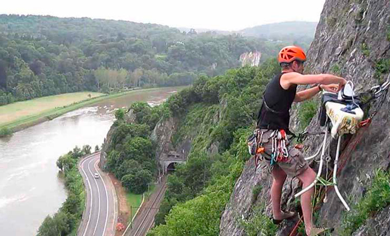 Extreme ironing rock climber
