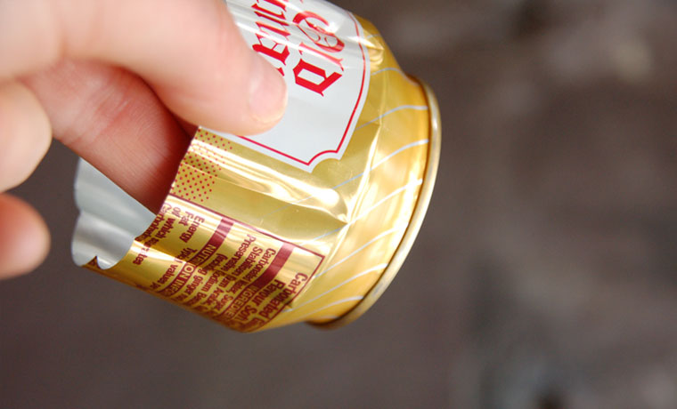 Close up of folds in the side of a soda can
