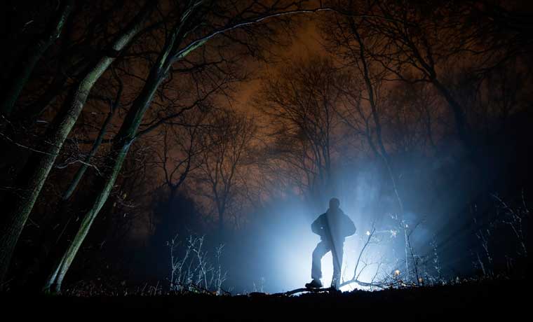 Spooky man in the woods at night