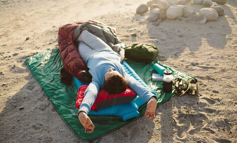 Sleeping on a camping pillow on the beach