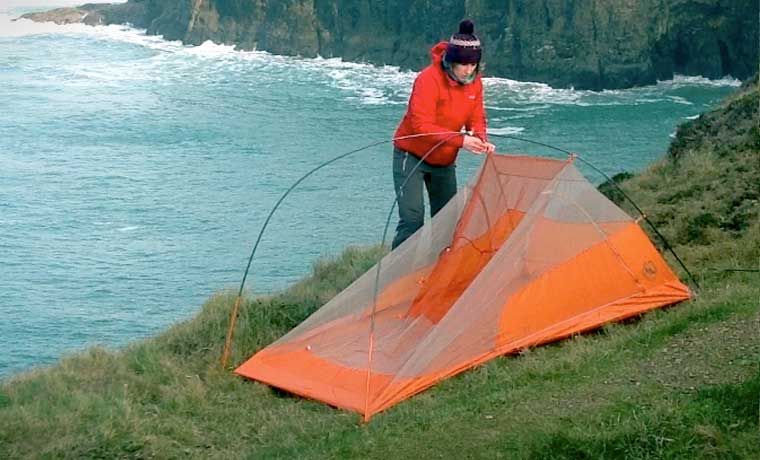 Woman showing how to set up a tent