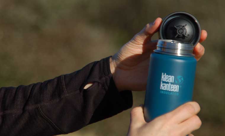 Open insulated flask in hands