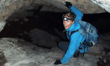 Woman wearing the best headlamp in a cave