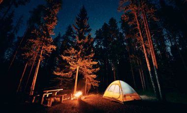 Camp fire and tent at night