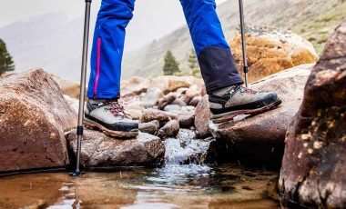 Crossing a stream in the best hiking boots for men