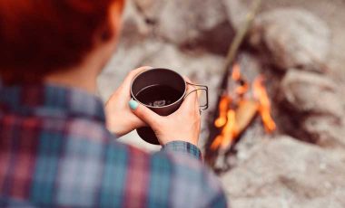 Drinking backpacking coffee by the fire
