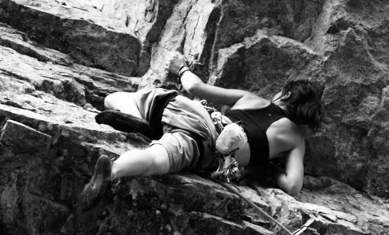 Woman climbing an overhang
