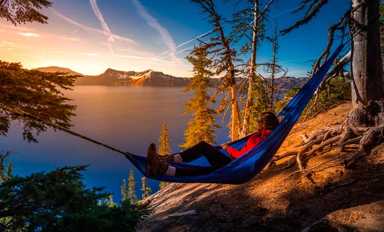 Woman in hammock by lake