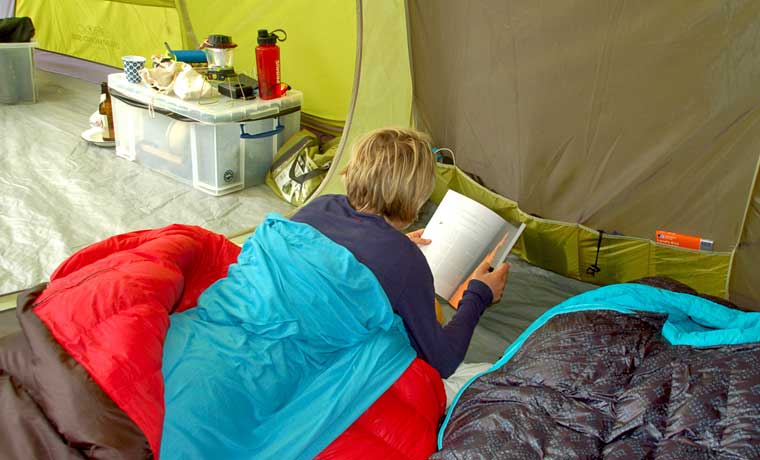 Woman reading in tent