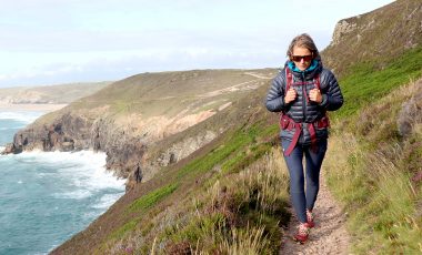 Woman hiking on coast path in leggings