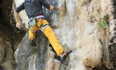 Man climbing on rock in the best climbing pants