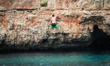 Man climbing over water