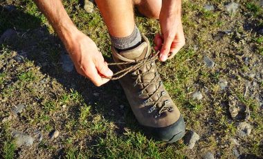 Person showing how to tie hiking boots