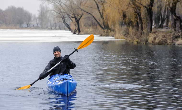 Man kayaking in cold weather