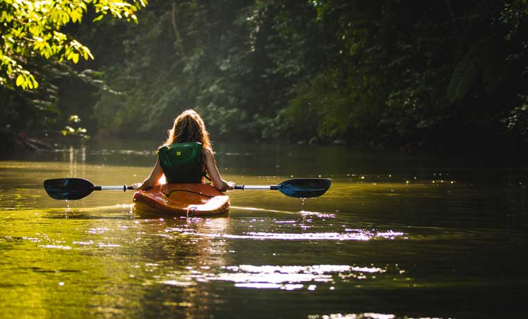 Woman kayaking on river