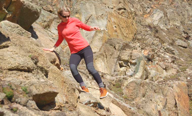 Woman on rocks in leggings