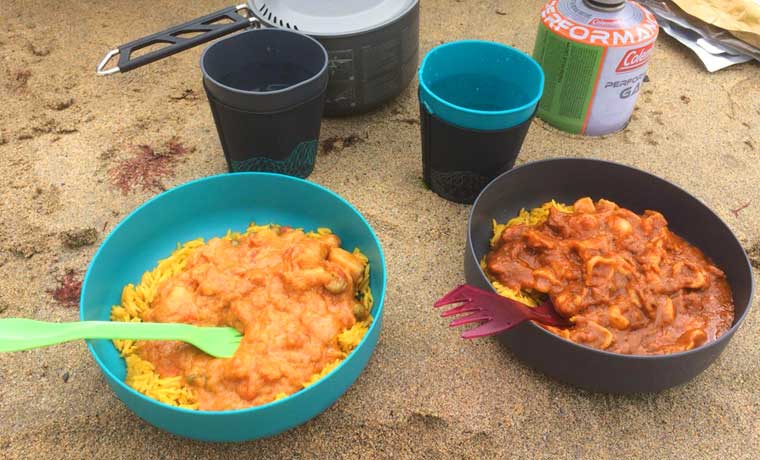 Bowls of food on beach