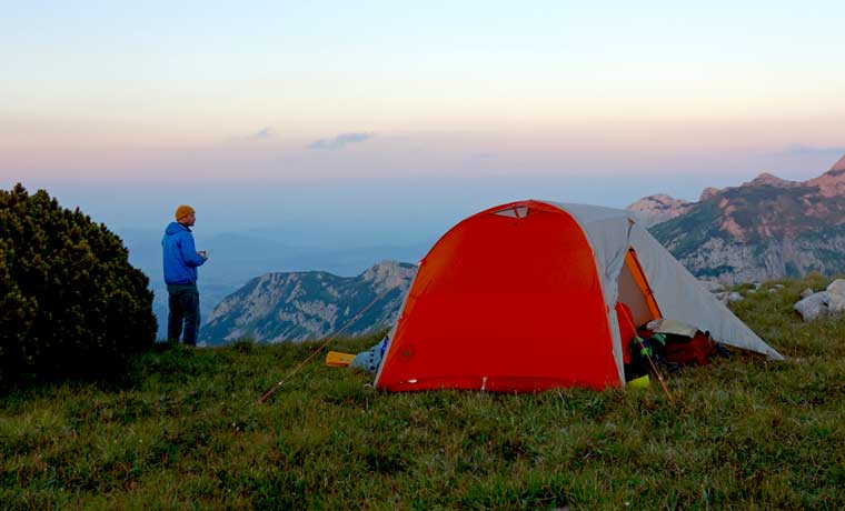Man and tent in mountains
