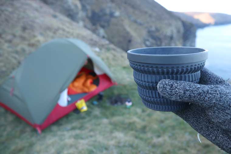 Mug held in front of tent