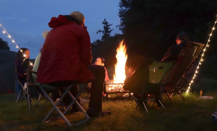 Family sitting around campfire