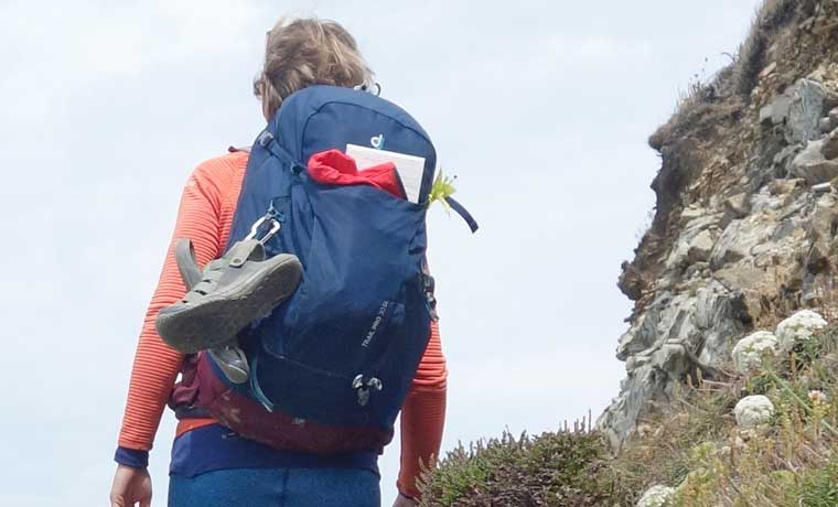 Hiking with shoes on backpack