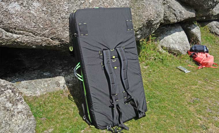 Backpack straps on bouldering mat