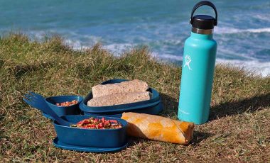 Packed lunch in eco-friendly lunch box by the sea