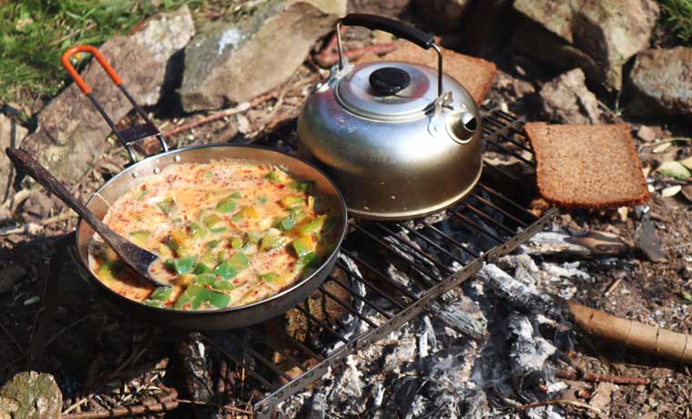 Kettle and food cooking on fire