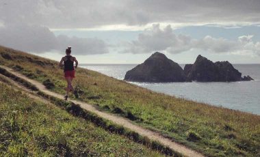 Woman trail running on coast