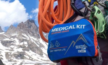 Climber carring first aid kit in mountains