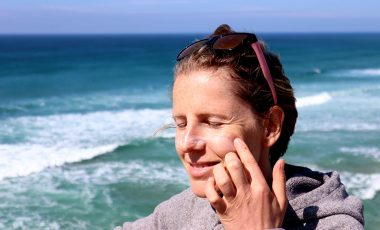 Woman applying eco-friendly sunscreen