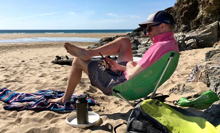 Man sitting in chair on beach