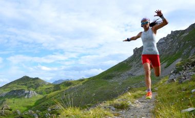 Woman trail running in the mountains