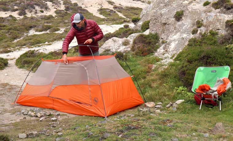 man putting up tent