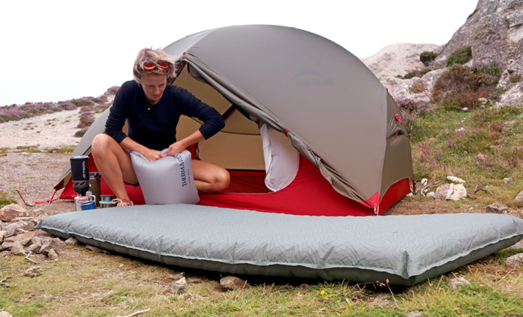 Woman inflating thermarest mattress